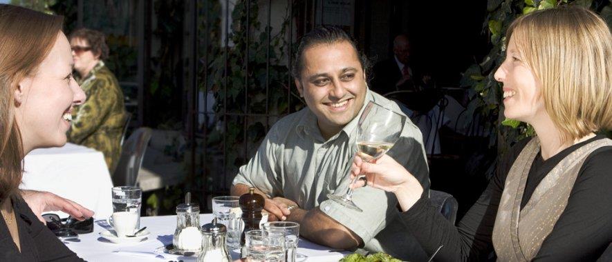 People at a table drinking wine. 