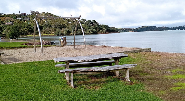 Blackpool Beach - Picnic table with the swing set and view of Huruhi Bay. Photo credit: K Sumner.
