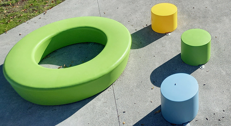 Onewherowhero / Brains Park - Brightly coloured round seats and table for small children.