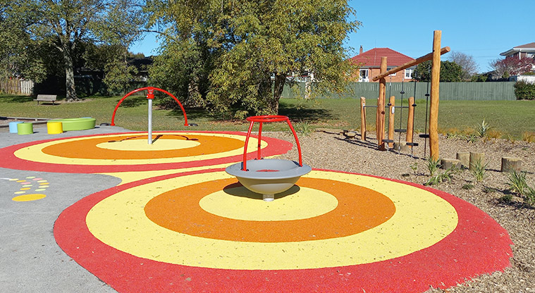 Onewherowhero / Brains Park - Spinning rocker with a spinning seesaw in the background.
