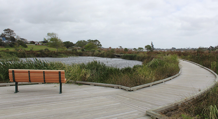 O-tua-uru / Brylee Drive Reserve - Section of boardwalk with a seat looking over the pond and wetland.