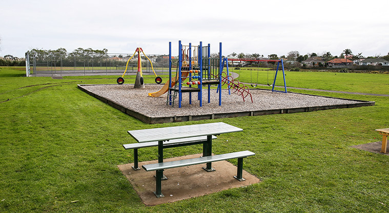 O-tua-uru / Brylee Drive Reserve - Playground with a picnic table and seating in the foreground.