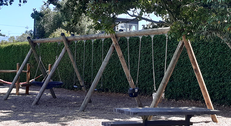 Centennial Park - Swing set with swings for all ages and abilities.
