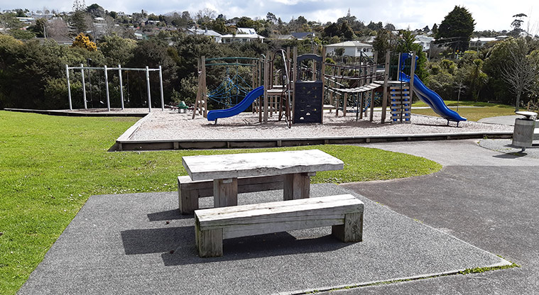 Ō-kauri-rahi / Ceramco Park - Picnic table and seating with the playground in the background.