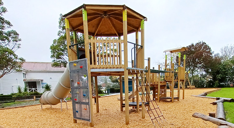 Collins Park - High play module with a climbing wall, net climbing ladder, platform, slide and monkey bars connecting to the low module.
