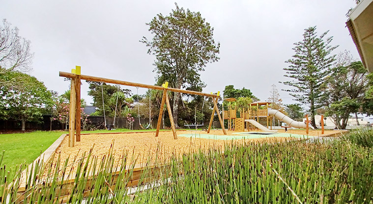 Collins Park - Playground on a raised bark base with swings, climbing towers, slides and more.