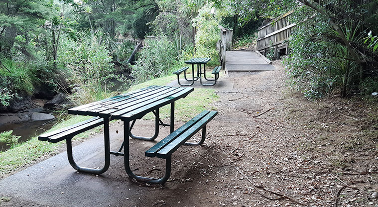 Cranwell Park - Two picnic tables by the stream.