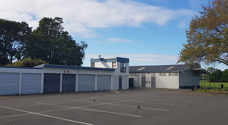 Eastdale Reserve - Section of the car park with community spaces and storage sheds in the background.