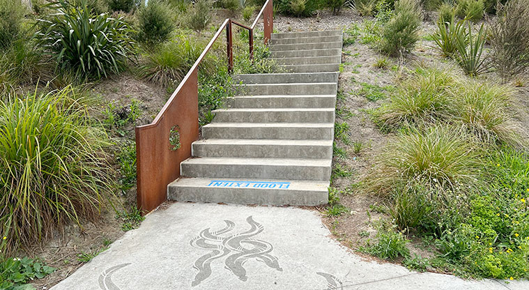 Freeland Reserve - Designs on the path representing Te Auaunga and the Tuna (eel), with steps leading up to another entrance to the reserve. Photo credit: S Hulse.