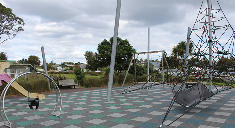 Heron Park - Section of the playground showing the large climbing net, and the swing and slide for preschoolers.