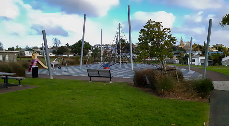 Heron Park - Playground with climbing structure, slide, bucket swing and spinning bucket.