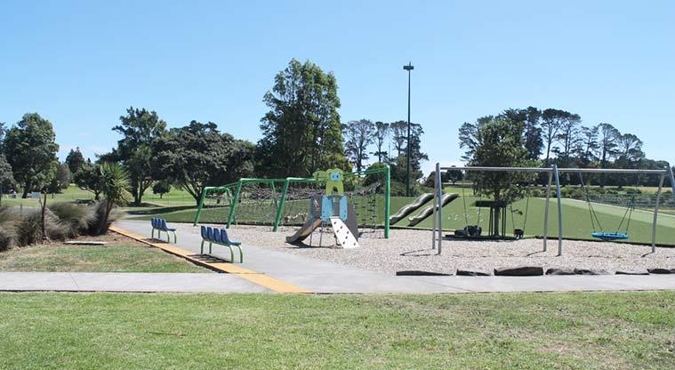 Keith Hay Park – Playground with set of swings, swinging basket, climbing frame, and double slides.