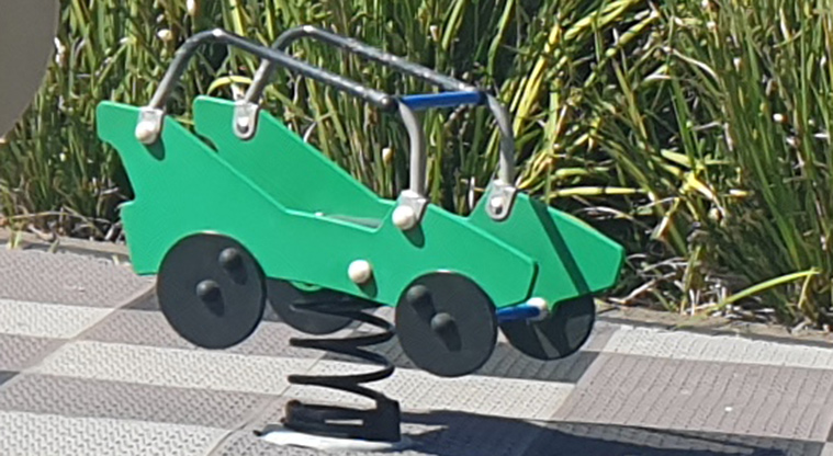 Kuaka Park - Bright green bouncy car in the upper playground. Photo credit: J Grigg.