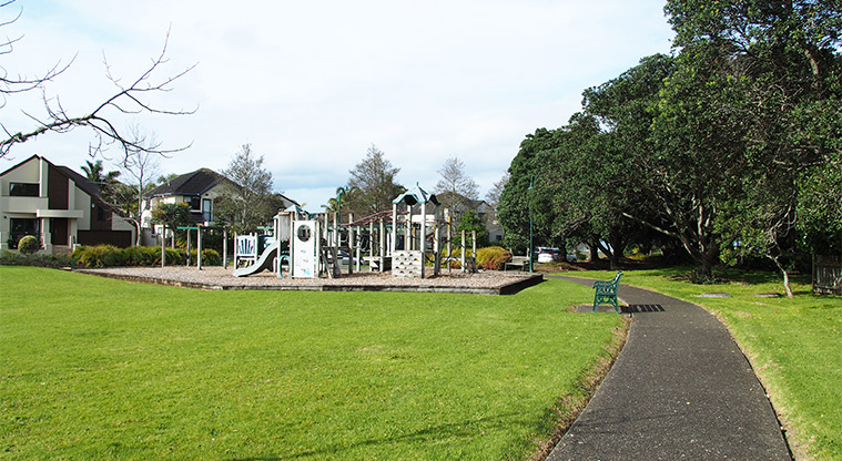 Lone Tree Park - Open grassed area with a path, seat and playground. Photo credit: Tracey Hodder.