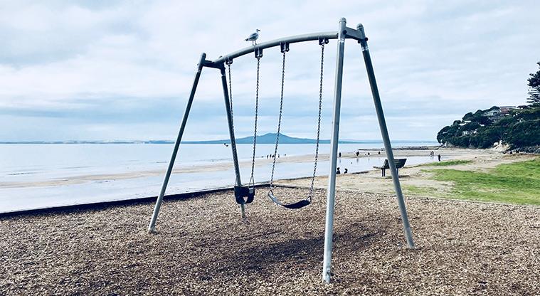 Mairangi Bay Beach Reserve - Set of two swings by the beach.