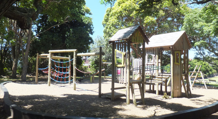 Melville Park - Wooden playground under the trees with climbing nets and towers, platforms, wobbly bridge, and more. Photo credit: J Grigg.