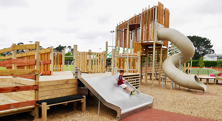 Moire Park - Tall tower with a long covered twisty slide from the top, climbing equipment, and a low wide slide.