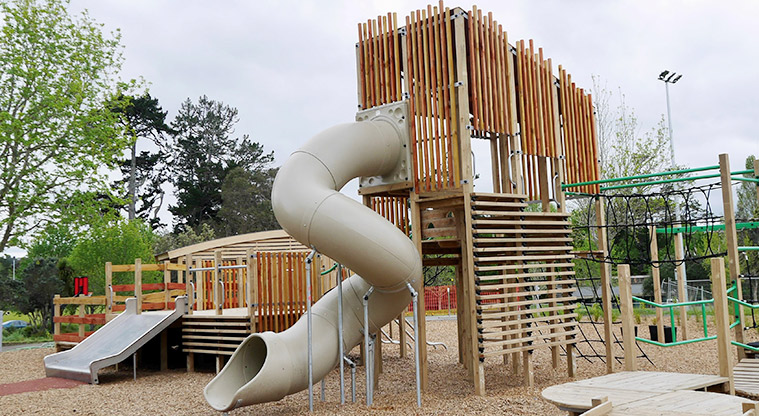 Moire Park - Tall tower with a long covered twisty slide from the top, climbing equipment, and a low wide slide.