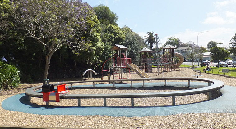 Maungawhau / Mount Eden – Raised mini train track with wooden toy train, and the rest of the playground in the background. Photo credit: J Grigg.