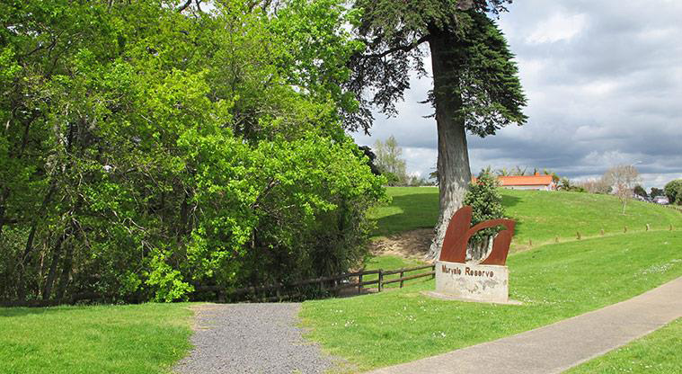 Murvale Reserve - Sign at the Murvale Drive entrance with bush and open space in the background.