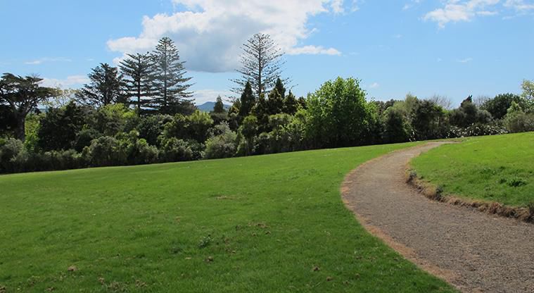 Murvale Reserve - Section of open grassed space with a path running along the right hand side and bush in the background.