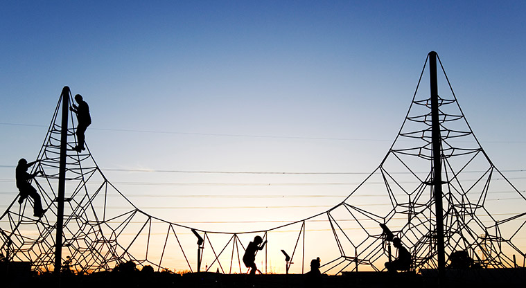 Olympic Park - Children enjoying playing on the climbing nets in the playground.