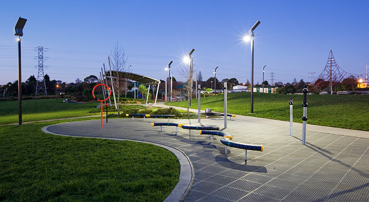 Olympic Park - Playground equipment lit up by solar-powered luminaries in the early evening.