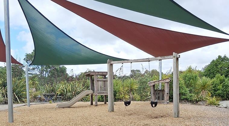 Onepoto Domain - The playground on a bark surface and with shade sails covering some of the play equipment.