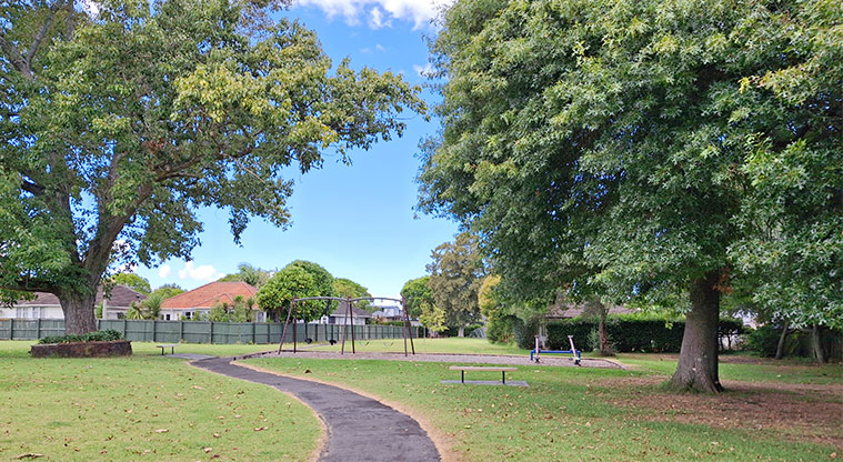 Orchard Reserve - Section of path leading through the trees to the playground in the background. Photo credit: T Hodder.