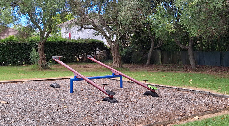 Orchard Reserve - Two seesaws with trees in the background. Photo credit: T Hodder.