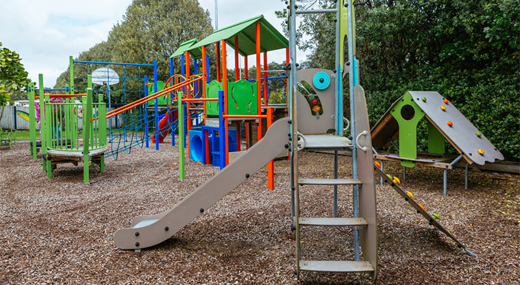 Ōrewa Beach Holiday Park playground slides and climbing equipment.