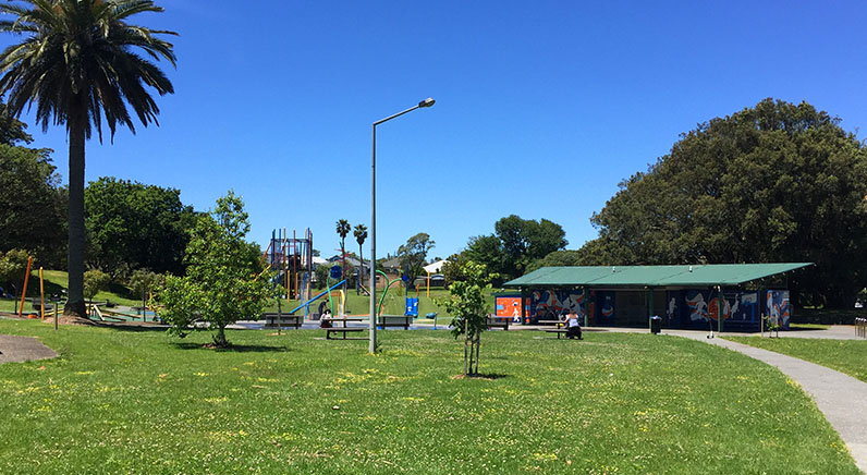 Potters Park – Open space with the playground and toilets in the background.