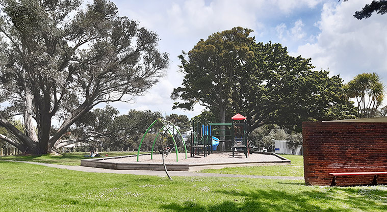 Pt Erin Park - Open grassed area with the playground and trees in the background. Photo credit: T Hodder.
