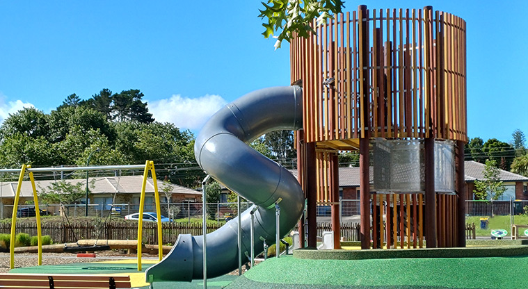 Rānui Domain - High climbing tower on a raised mound with a grey enclosed tube slide.