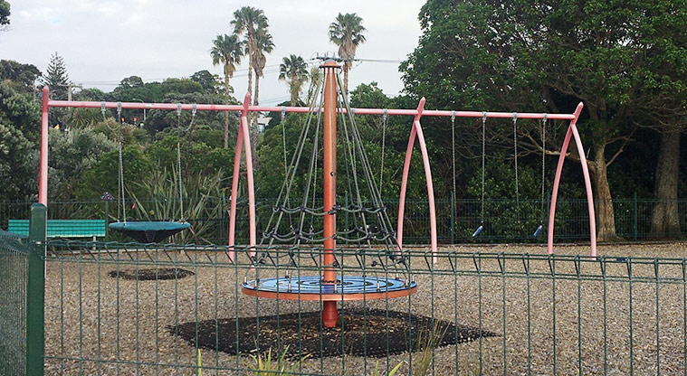 Roberta Reserve - Lunar net spinner with a set of swings in the background.