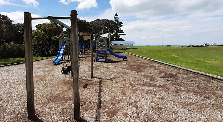 Rothesay Bay Beach Reserve - Playground with swings, two bright blue slides, ramps, climbing equipment and more.