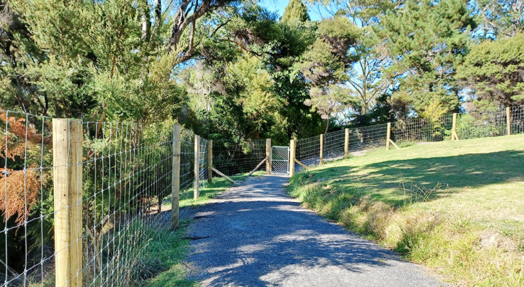 Sanders Reserve - Section of the fully fenced dog exercise area with one of the entrance gates and a gravel path.