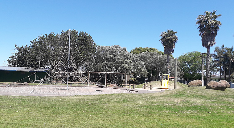 Seaside Park - High spider climbing net with the double yellow slide in the background.