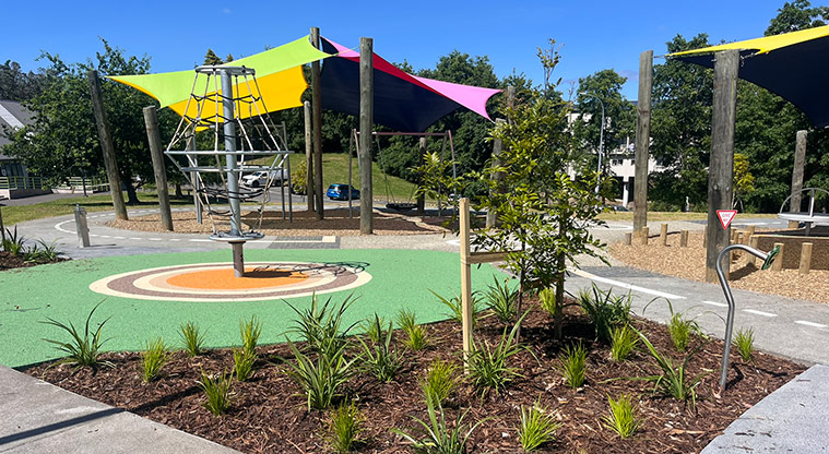 Shepherds Park – Section of garden with the net twister and part of the playground under shade sails in the background.