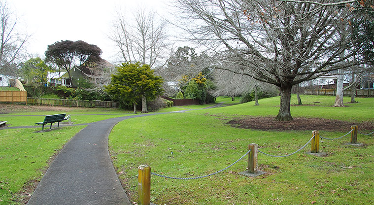 Rengarenga / St Margarets Park - Entrance to the park with bollards and chains, a path through the park and a bench seat next to the path. Photo credit: Tracey Hodder.