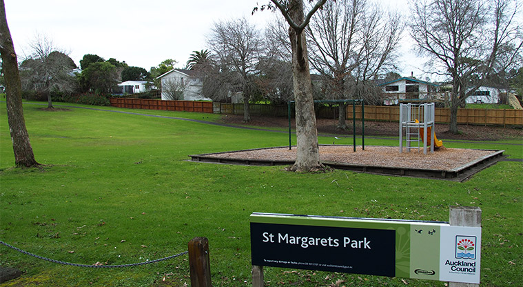 Rengarenga / St Margarets Park - Sign at the entrance to the park with the playground, trees and open space in the background. Photo credit: Tracey Hodder.