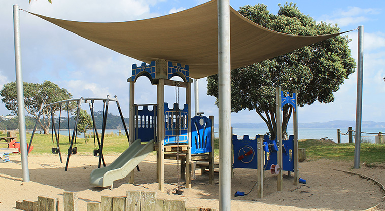 Stanmore Bay Park - Preschool playground with slide and swings under a shade sail. Photo credit: M Loubser.