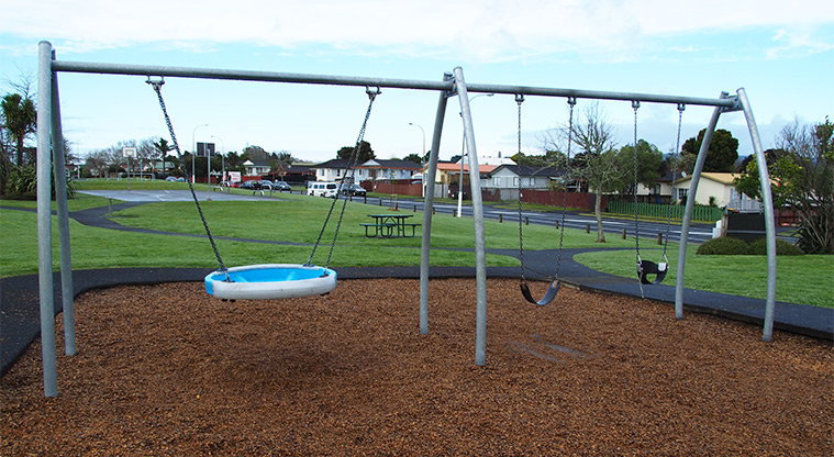 Starling Park - Swing set with a picnic table. paths and open space in the background. Photo credit: Tracey Hodder.