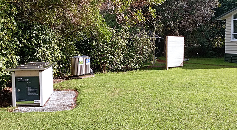 Surfdale Hall Reserve and Foreshore - Barbecue, rubbish bins and the beach shower with open grassed space in the foreground. Photo credit: K Sumner.