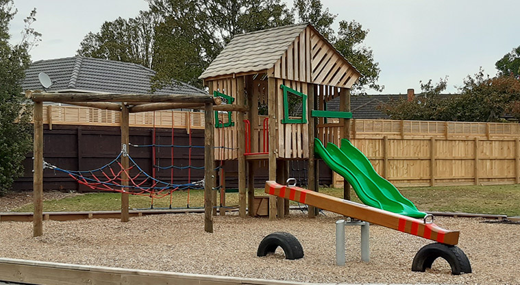 Te Atatu Peninsula Park - Cubby house with climbing nets and a double slide, and a wooden seesaw. Photo credit: Tracey Hodder.