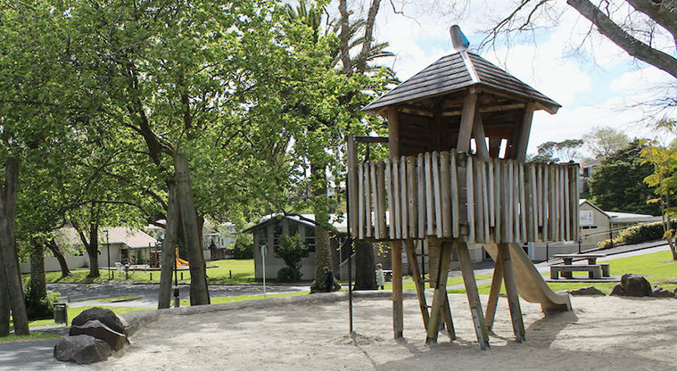 Tūī Glen Reserve - Small tower with a slide running into the sand play area.