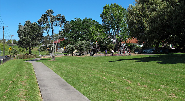 Turner Reserve - Grass area with mature trees and the playground in the background. Photo credit: S Hulse.
