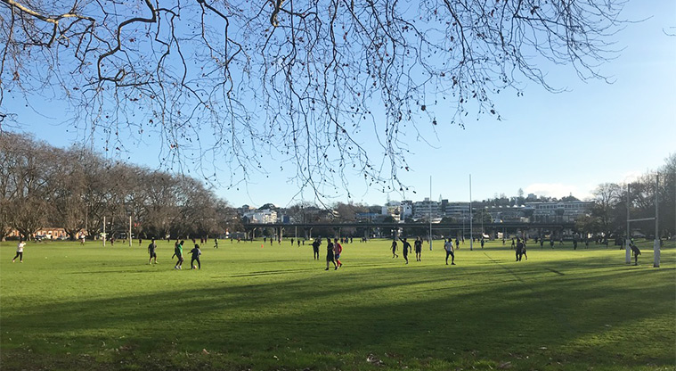 Victoria Park - Sports field with people playing rugby.