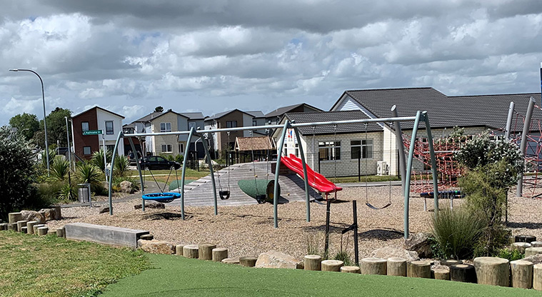 Waimāhia-ki-uta / Waimahia Park - Section of the playground showing the set of five swings, and climbing hill with a tunnel.