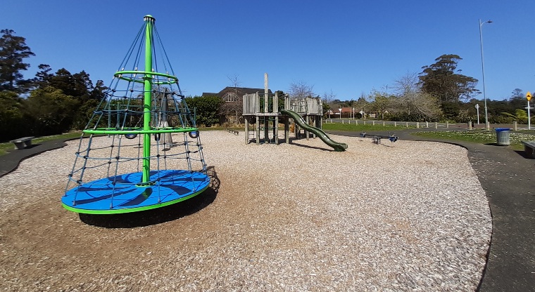 Xena Park - Playground with climbing tower and slide in the background. Photo credit: Tracey Hodder.